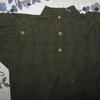 Black and olive plaid, 3 button front, one on the collar and two on the placket. This shirt is a Medium of yarn dyed woven cotton. The modern buttons resemble early bone buttons. $38.00